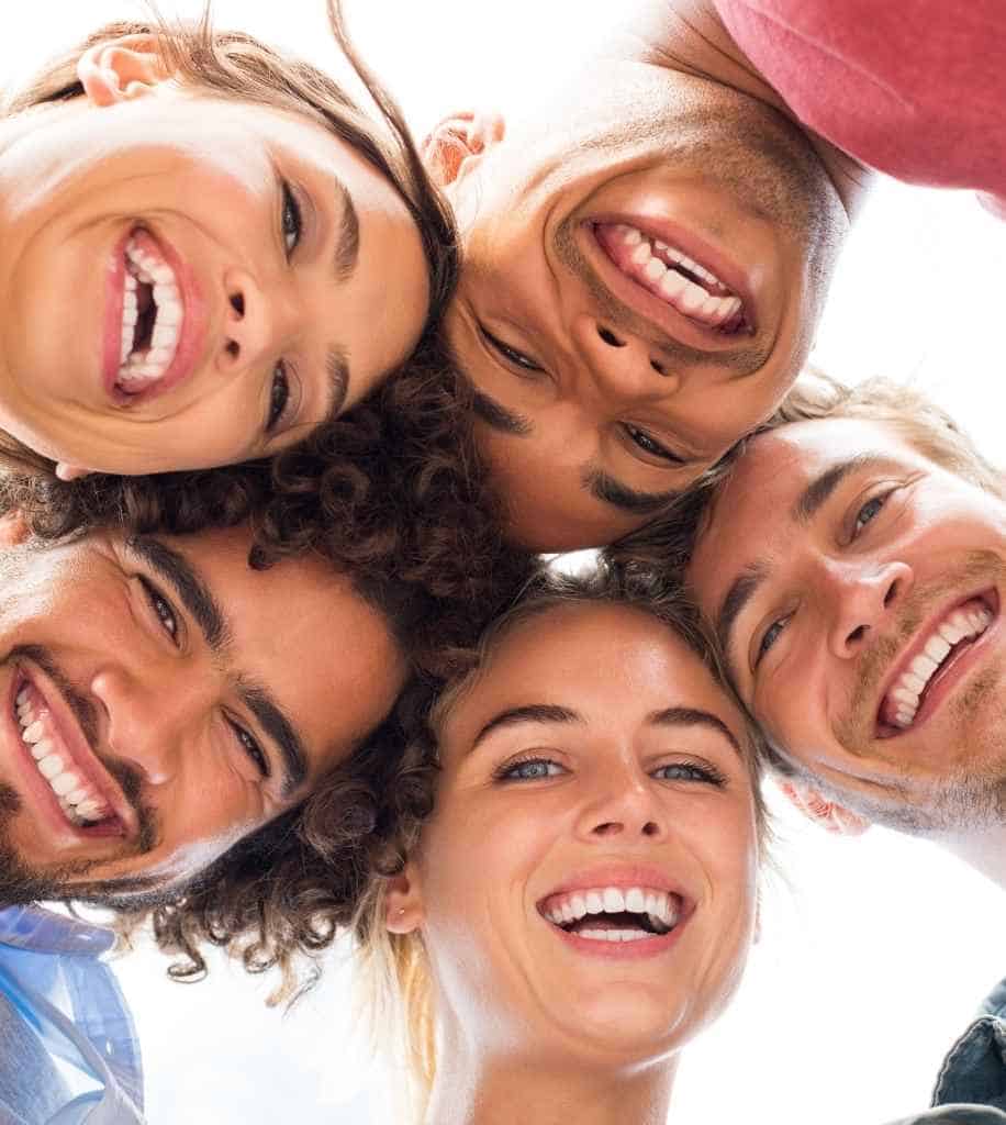 Smiling person showcasing white teeth after laser whitening treatment Cambridge